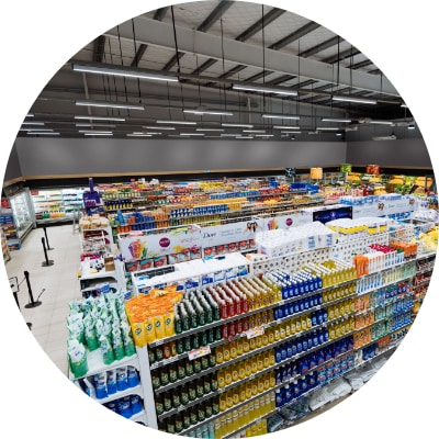 Aisles and shelves in supermarket, wide angle view.