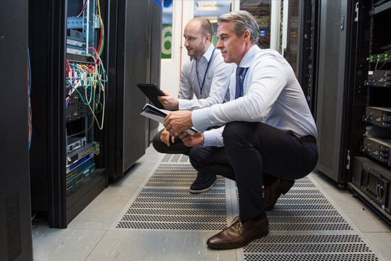 Workers performing server room inspection.