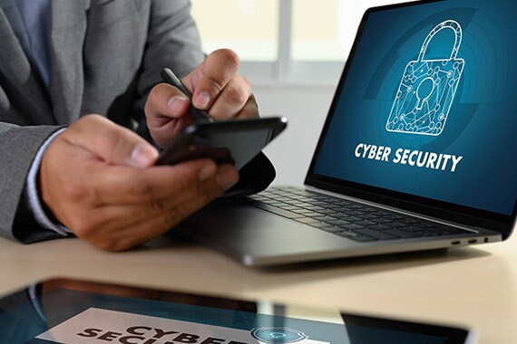 Man working on laptop that features cyber security software