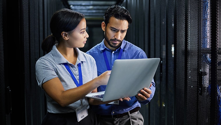 azure image with coworkers in server room on a laptop.