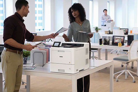 Coworkers at an office printer