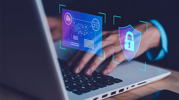 Cybersecurity dashboard overlay with digital shield and security controls displayed above a laptop keyboard, representing automated vulnerability remediation, SonarQube findings management, and secure software development workflows.
