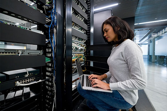 Experienced IT engineer configuring servers in a secure data center environment.