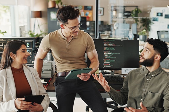 IT professionals collaborating in an office to plan and deliver technology solutions.