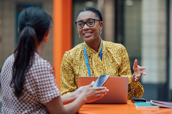 Smiling instructor engaging with a student during a one-on-one session, representing award-winning teaching and exceptional course delivery.