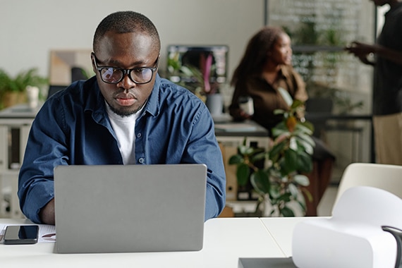 Person in office using secure firewall on laptop