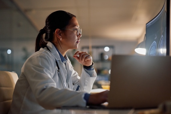 A physician using a desktop computer.