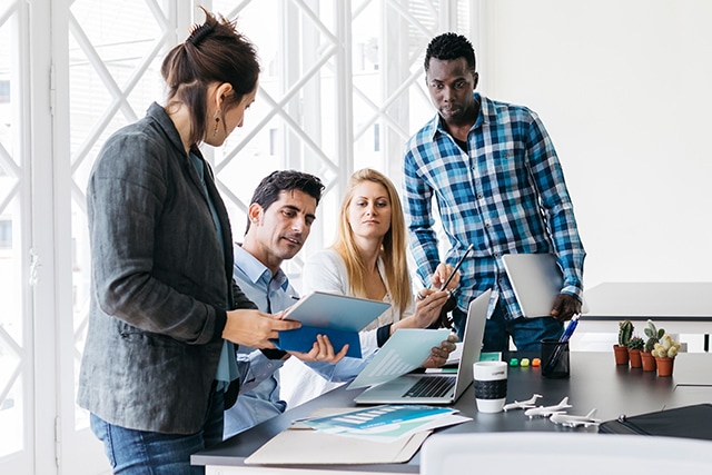 Coworkers working in bright office.