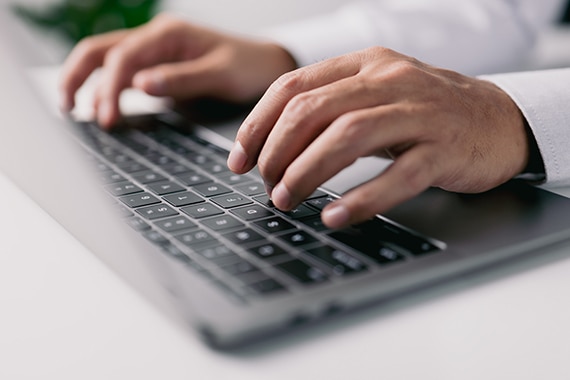 card thumbnail image of hands typing on a laptop keyboard