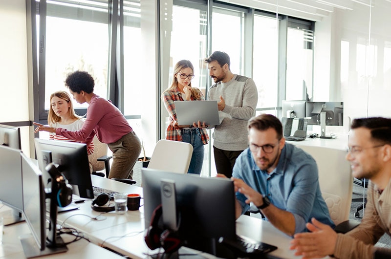 Coworkers collaborating in a bright office.