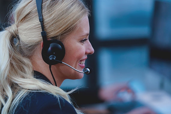 Close-up of support professional wearing headset in office environment