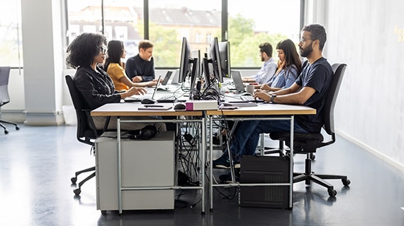 People working at desks in bright modern office.