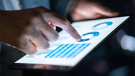 Global threat intelligence data on tablet highlighting AI-powered cyber attacks, social engineering tactics, and evolving security risks across industries