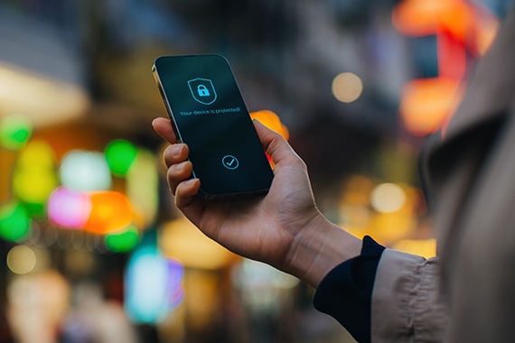 Woman checking her smartphone for security settings.