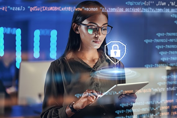 Woman working on a tablet in an IT security environment.