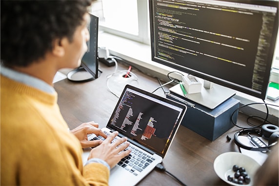 Image of a man looking at his laptop