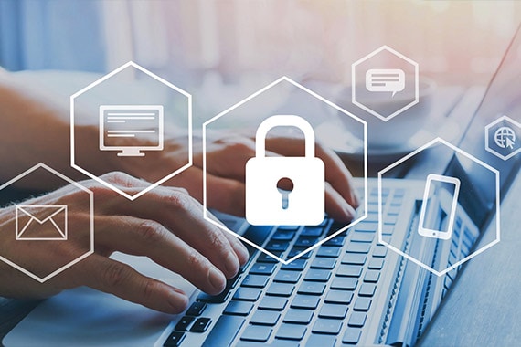 Hands typing on a keyboard with cyber security icons
