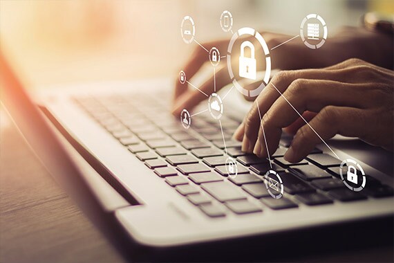 Cybersecurity professional working on a laptop
