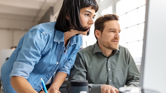 Coworkers collaborating in bright office.