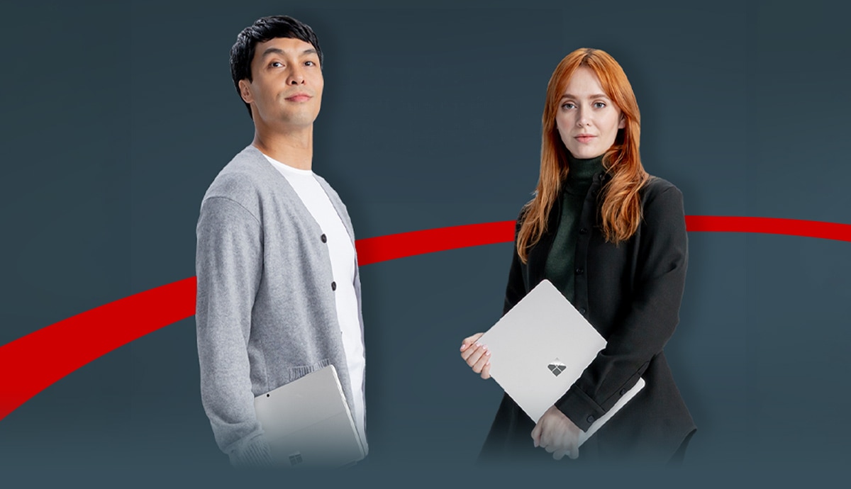 Two business professionals carrying Microsoft Surface laptops powered by Intel Core Ultra processors, ready to enhance productivity with on-device AI