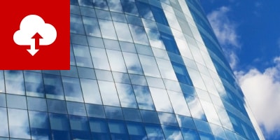 picture of a high rise building reflecting clouds