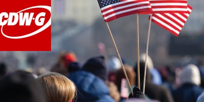 Three american flags in a crowd of people