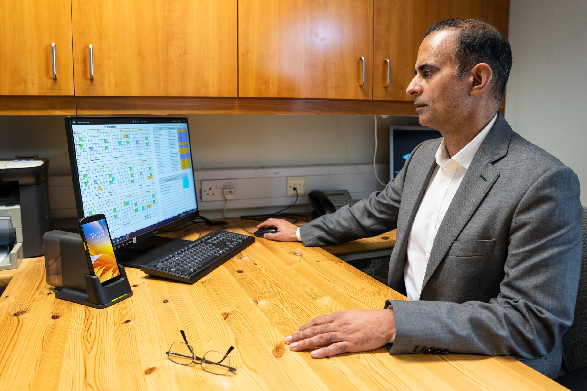 Person typing on a computer while working in the office.
