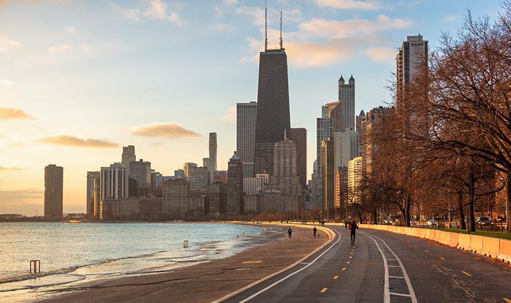 City skyline surrounded by an ocean at dusk