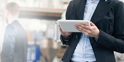 Individual holding tablet