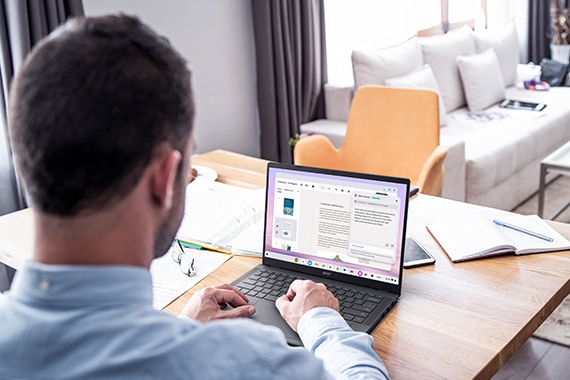 thumbnail image of a man working on a laptop computer from his home office