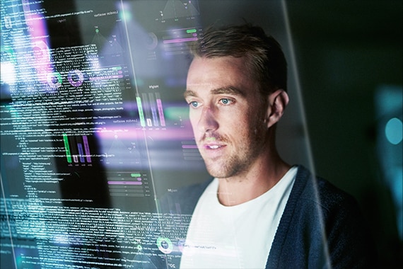 thumbnail image of an IT specialist using AI tools on a monitor display