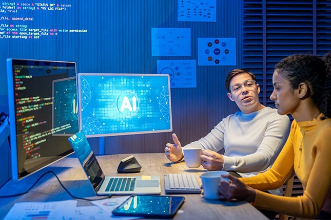 Two professionals reviewing AI software development tools on multiple screens