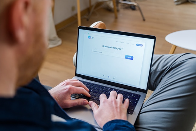 thumbnail image of a man using an AI-powered assistant on a laptop computer