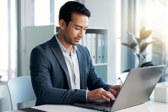 Data analysis, research and businessman with a tablet and laptop for accounting or economy growth. Office, Asian and financial worker with technology for email, planning or information on a website