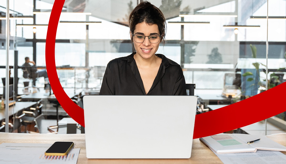Woman using laptop in a bright office.