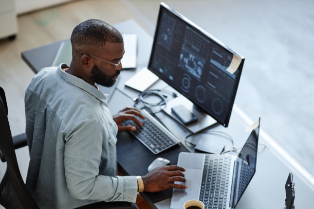 Man working on computers in an office.