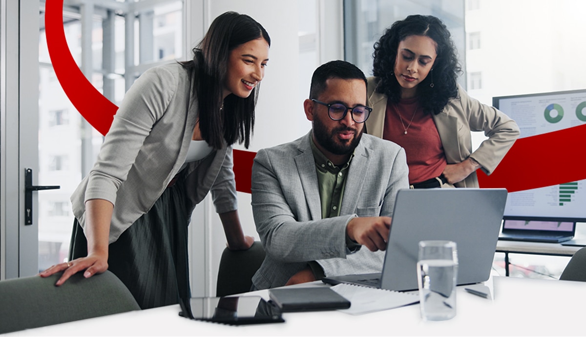 Coworkers in bright office on laptop