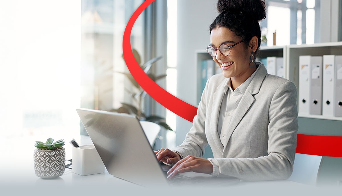 Government professional using a laptop in a modern office, representing secure, scalable AWS cloud solutions for public sector agencies
