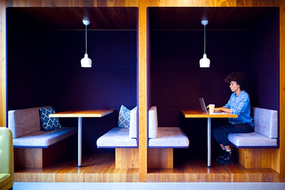 card thumbnail image of a woman working on a laptop in a modern workspace