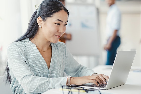 woman working on work laptop in an office