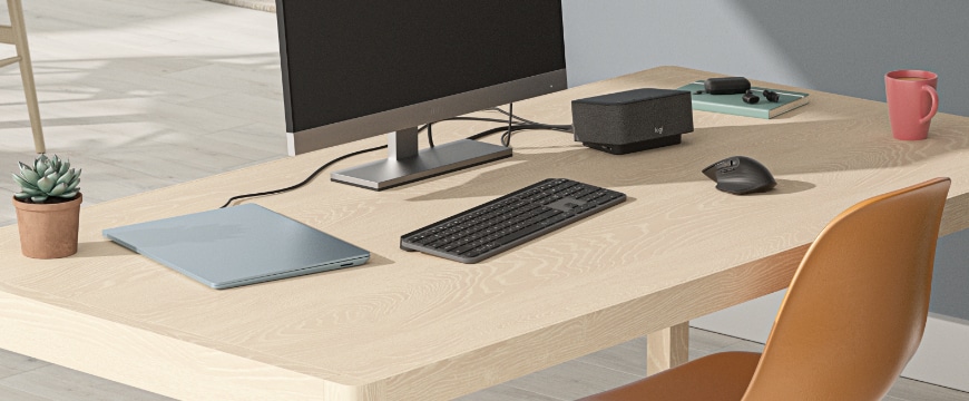 Image of a home office desktop with Logitech accessories.