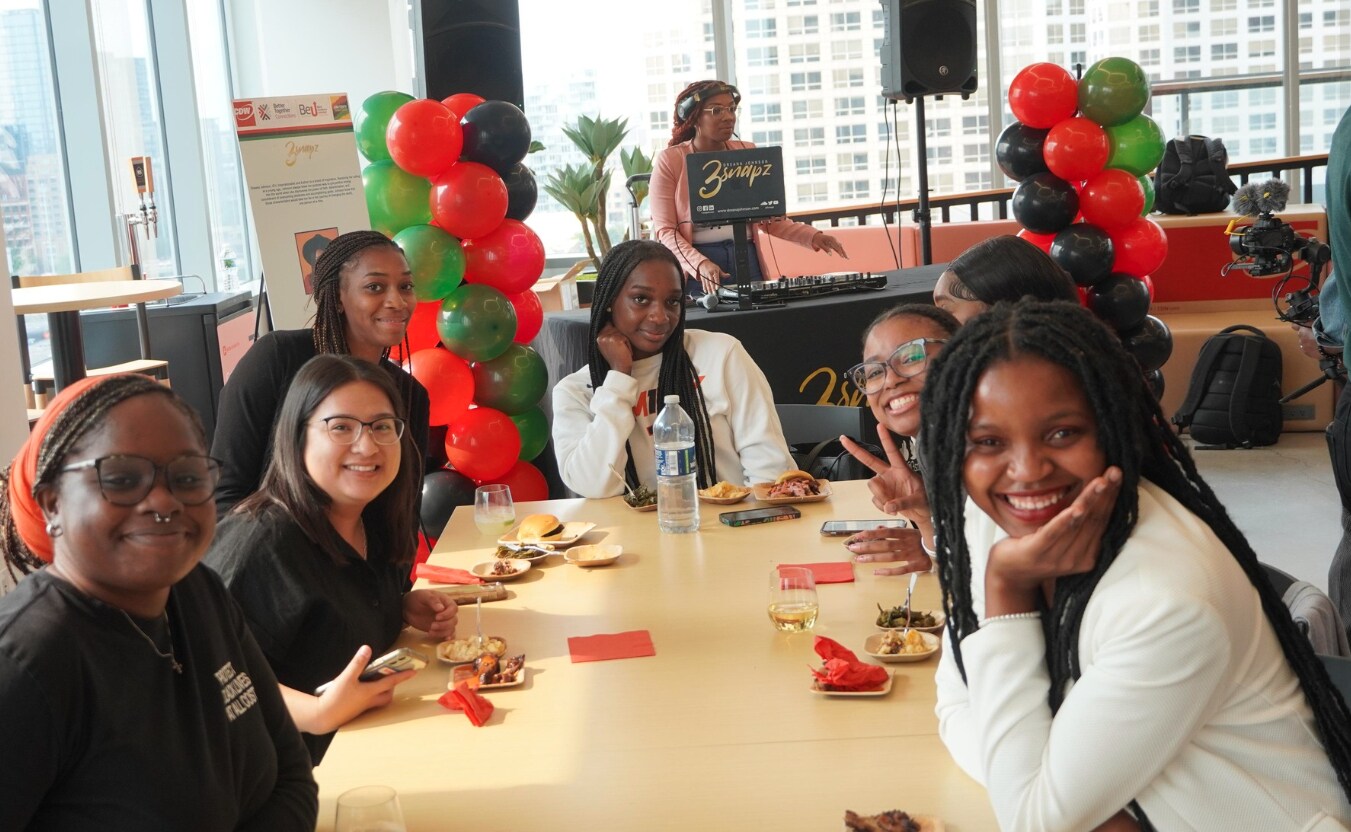Members of CDW’s Black Excellence Unlimited Business Resource Group sit around a table during Juneteenth celebration event.