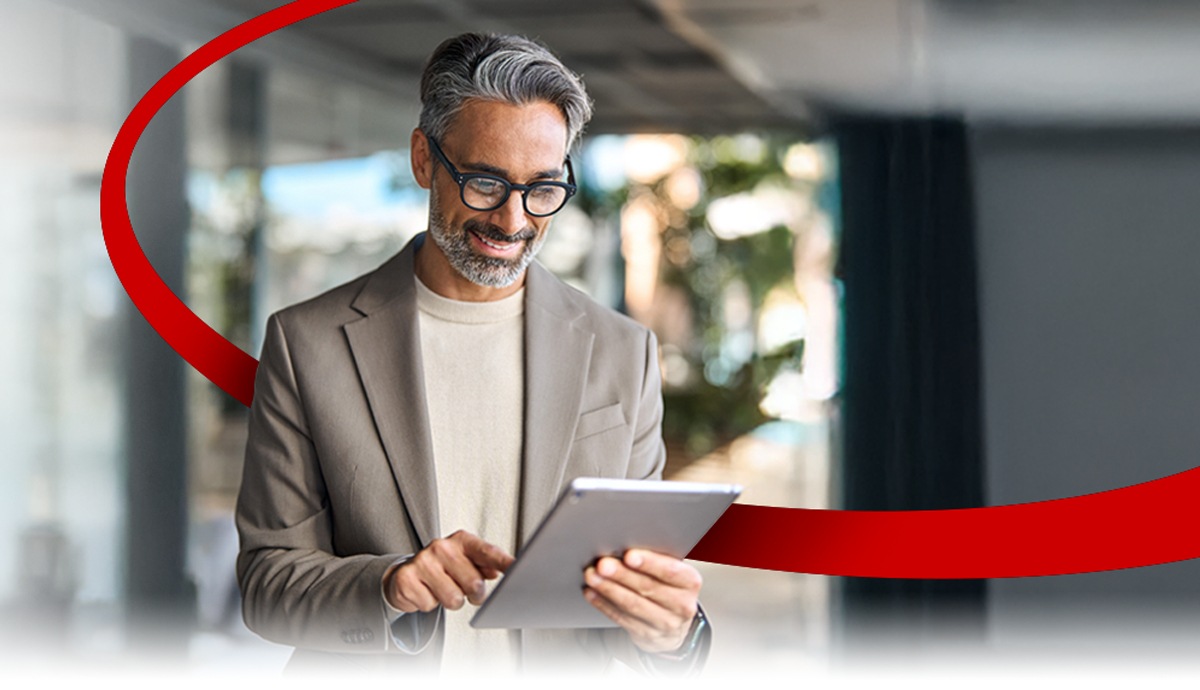 image of a business man holding a tablet smiling