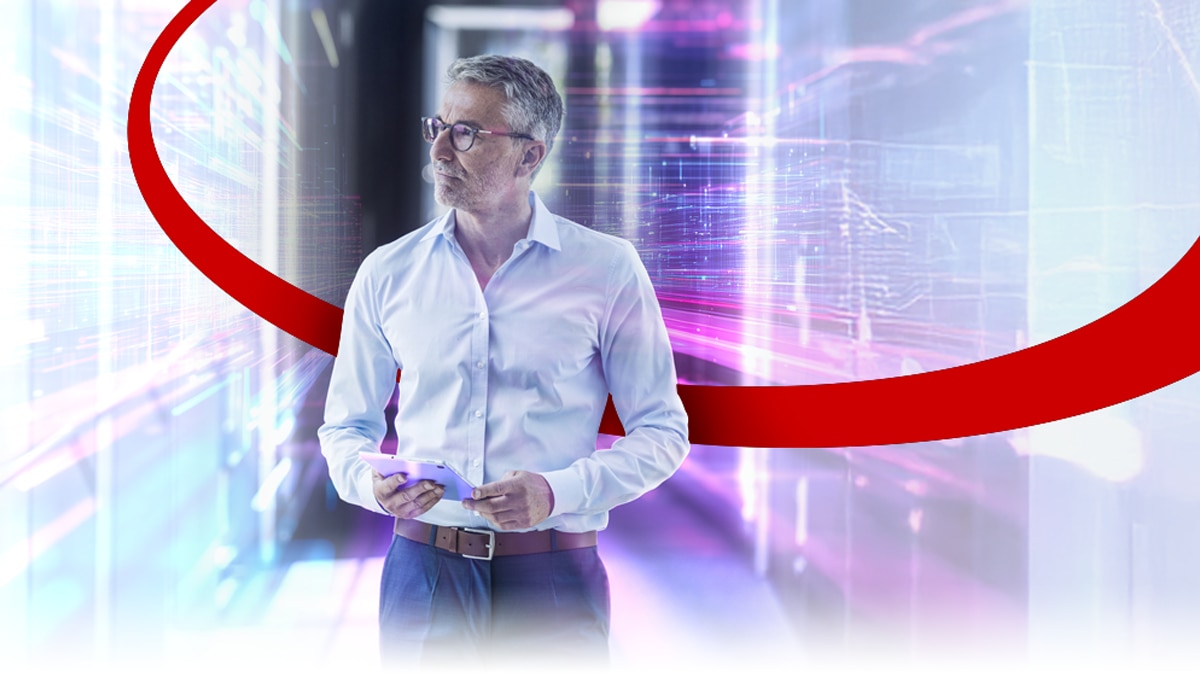 Experienced IT Professional holding a tablet inside a data center