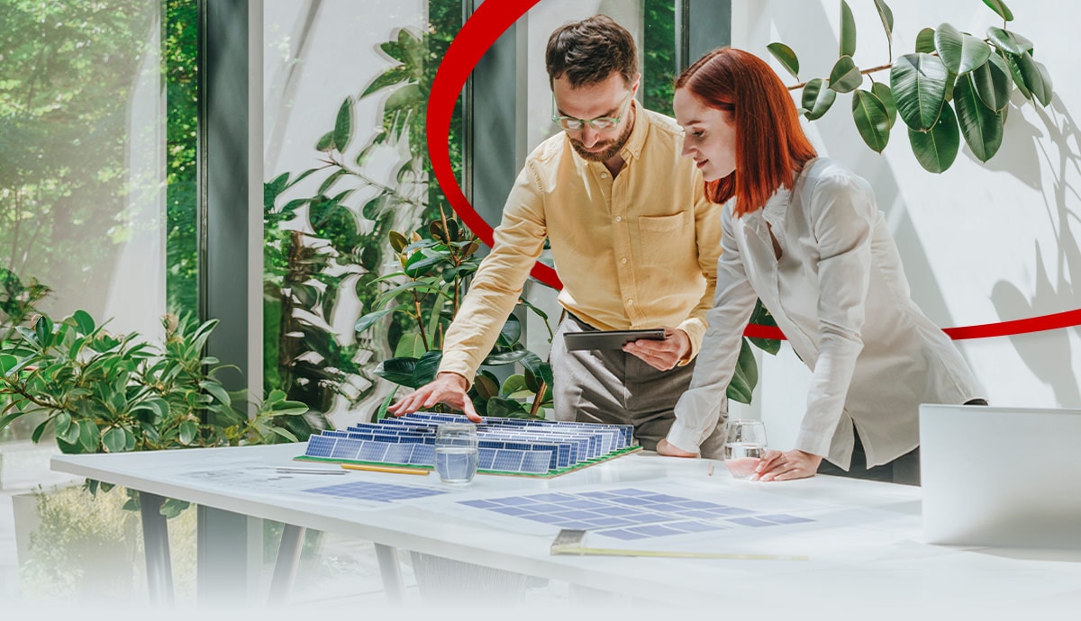 Businessman having discussion with colleague over solar panel model