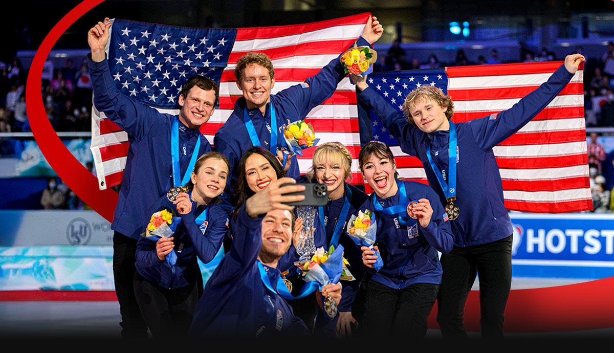 Team USA figure skaters celebrate with medals, flowers, and American flags after a competition.