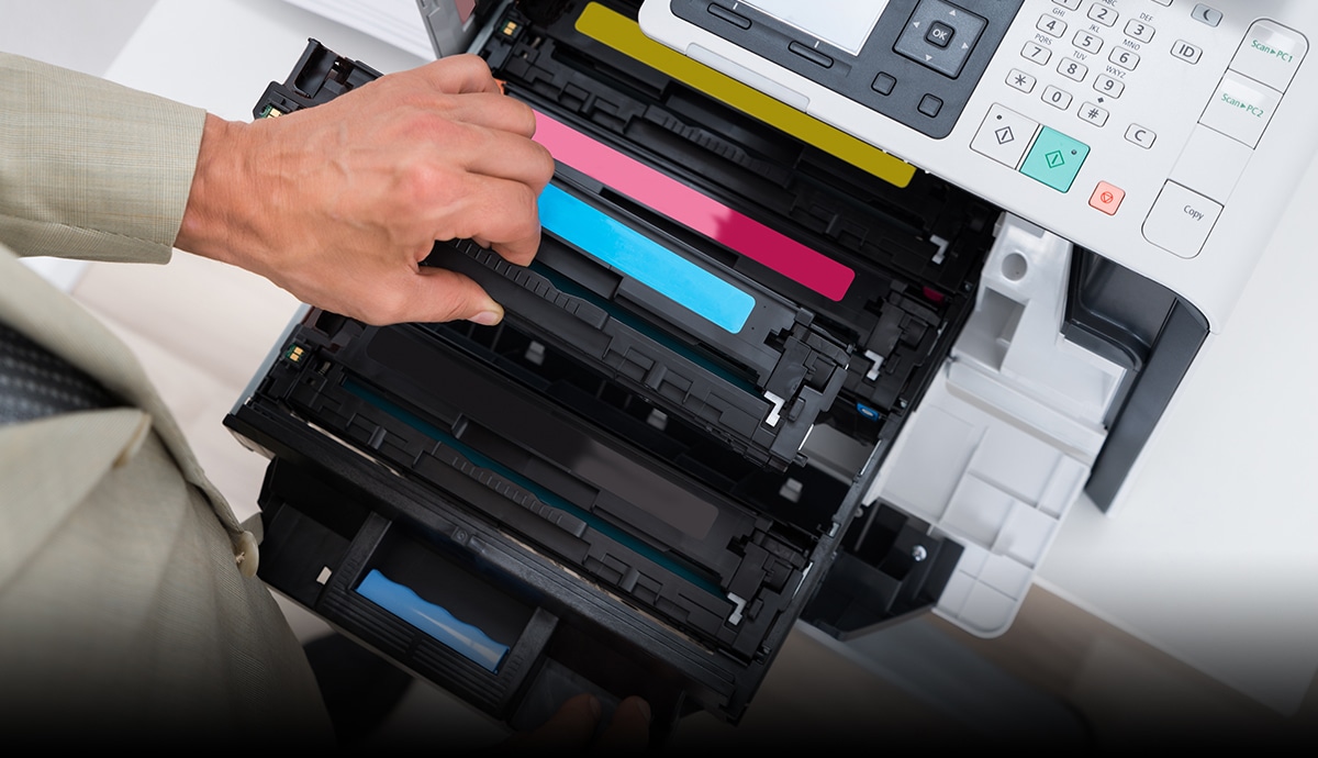 image of a man replacing a printer cartridge