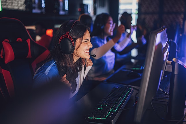 School Esports Team playing sports video games on PC computers.