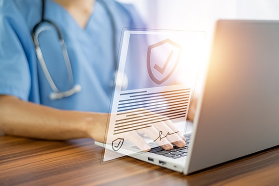 healthcare security image of doctor reviewing secure documents on a laptop
