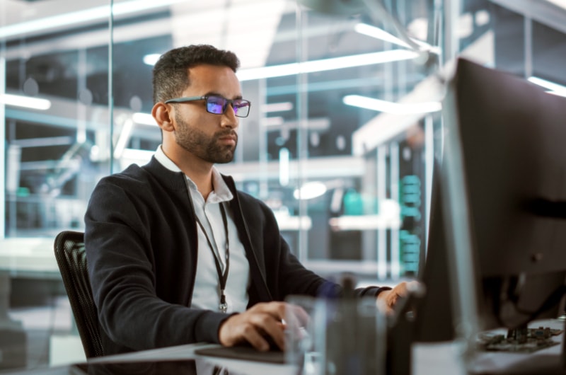 An IT admin looking at a desktop computer.